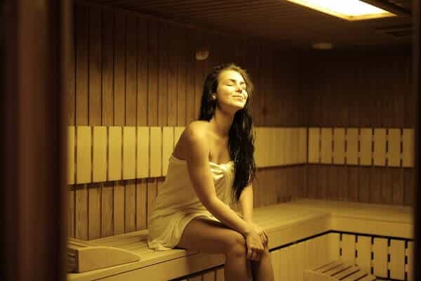A beautiful woman sitting in a sauna